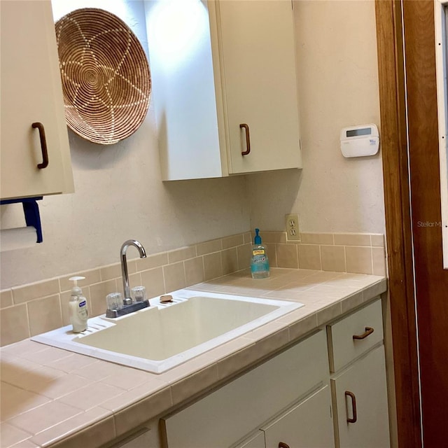 1428 Pine Island Ct, Punta Gorda, FL 33950 - interior space featuring tile countertops, white cabinetry, and a sink