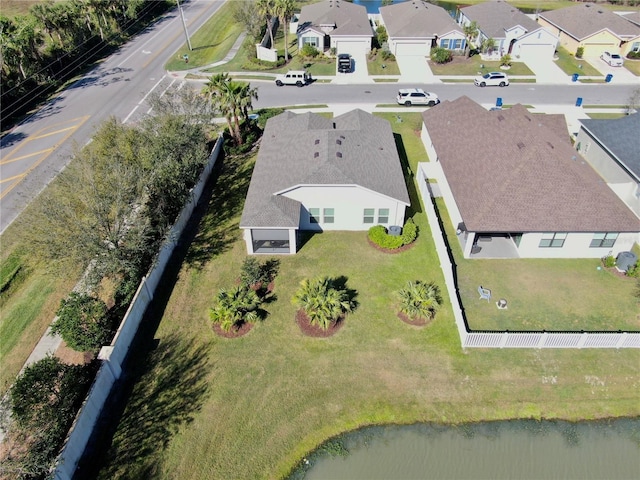 drone / aerial view featuring a residential view and a water view