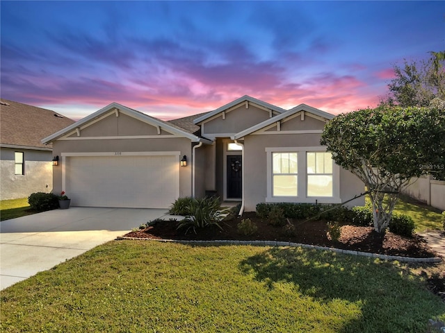 single story home featuring stucco siding, a yard, concrete driveway, and an attached garage