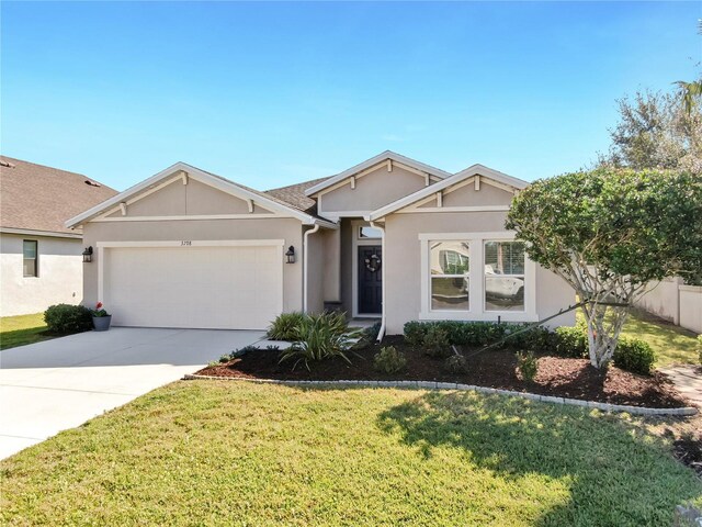 single story home with a front lawn, a garage, driveway, and stucco siding