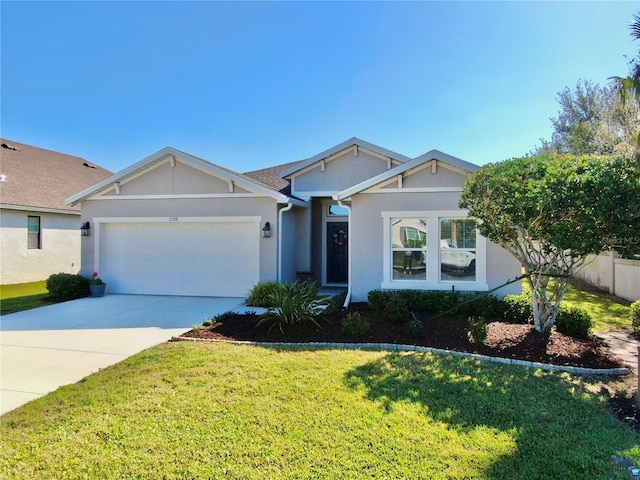 ranch-style home featuring concrete driveway, a garage, a front yard, and stucco siding