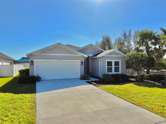 single story home with a garage, concrete driveway, a front yard, and fence