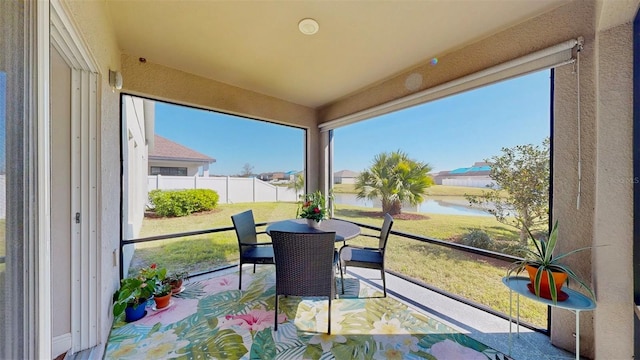 sunroom / solarium with a water view