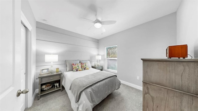 carpeted bedroom with baseboards and a ceiling fan