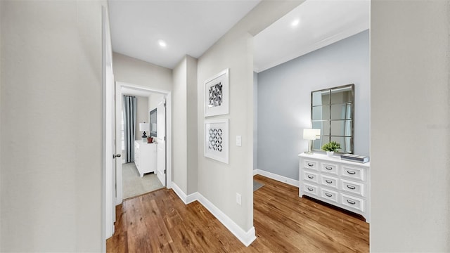 corridor with baseboards and wood finished floors