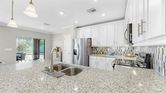 kitchen featuring crown molding, decorative backsplash, white cabinets, stainless steel appliances, and a sink