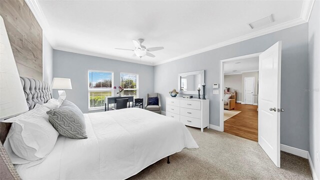 bedroom with baseboards, light carpet, a ceiling fan, and crown molding