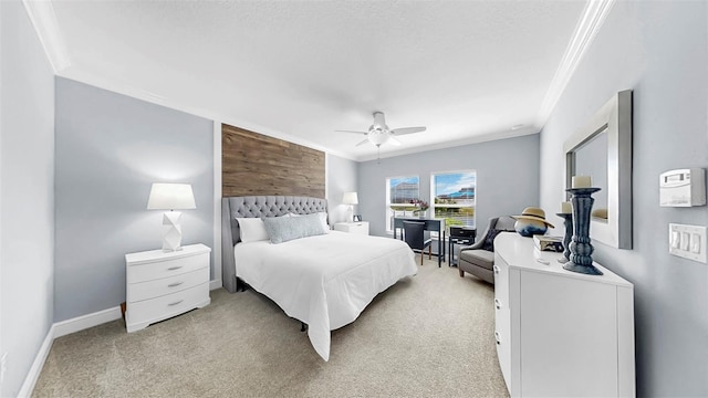 bedroom with wooden walls, crown molding, baseboards, light carpet, and a ceiling fan