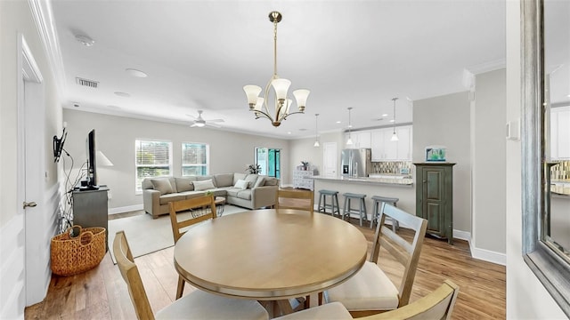 dining room with visible vents, recessed lighting, crown molding, light wood finished floors, and baseboards