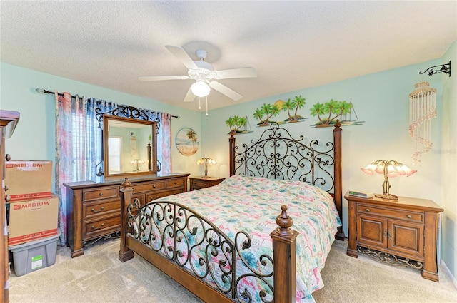 bedroom with light carpet, a ceiling fan, and a textured ceiling
