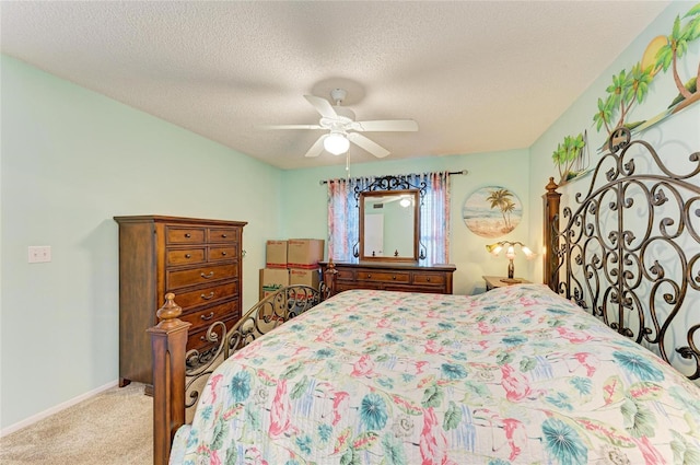 bedroom featuring light carpet, a textured ceiling, a ceiling fan, and baseboards