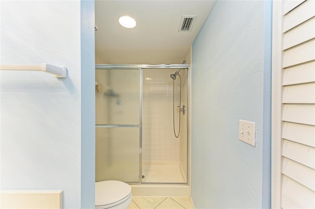 full bath featuring tile patterned flooring, visible vents, a shower stall, and toilet