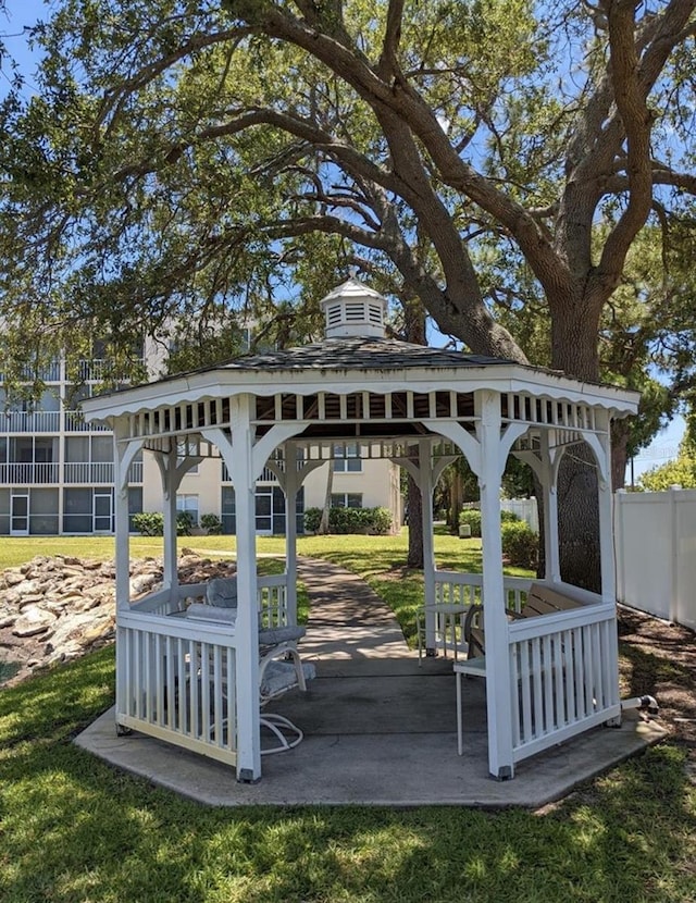 view of home's community with a gazebo, a yard, and fence