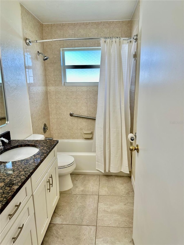 bathroom featuring toilet, tile patterned flooring, vanity, and shower / tub combo with curtain