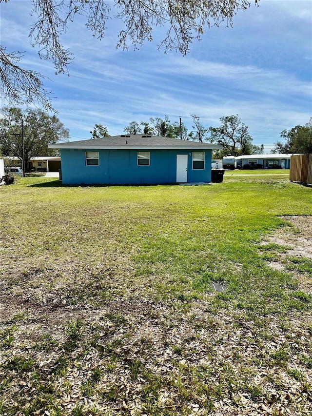 exterior space with a lawn and stucco siding