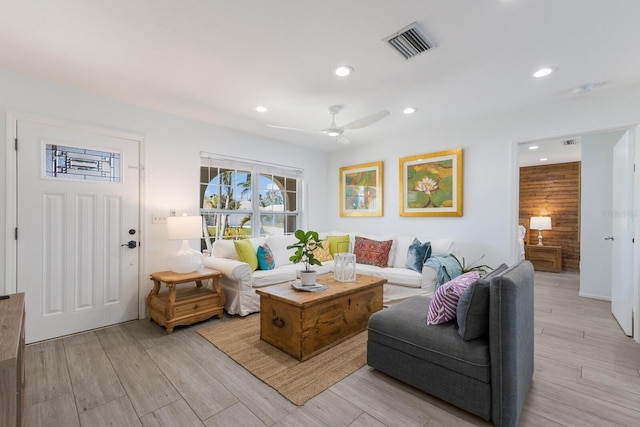 living room featuring a ceiling fan, recessed lighting, visible vents, and light wood-style flooring