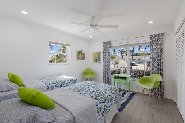 bedroom with multiple windows, a ceiling fan, wood finished floors, and recessed lighting