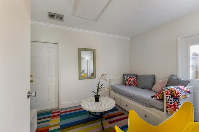 interior space featuring baseboards, visible vents, and ornamental molding