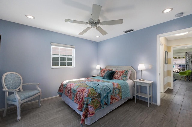 bedroom with baseboards, multiple windows, visible vents, and dark wood finished floors