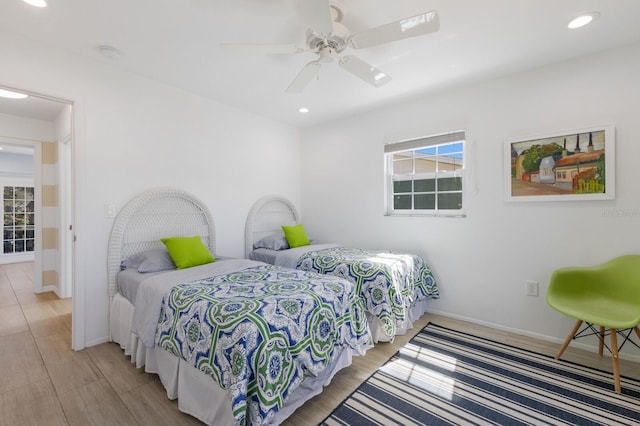 bedroom featuring baseboards, ceiling fan, light wood-style flooring, and recessed lighting