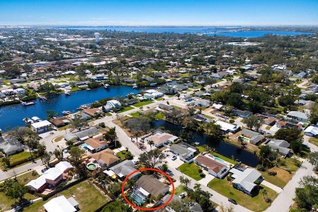 birds eye view of property with a water view and a residential view