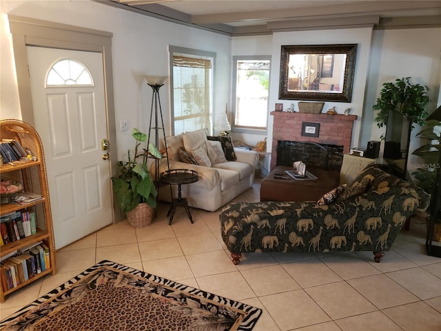 living area with a fireplace, beamed ceiling, and light tile patterned flooring