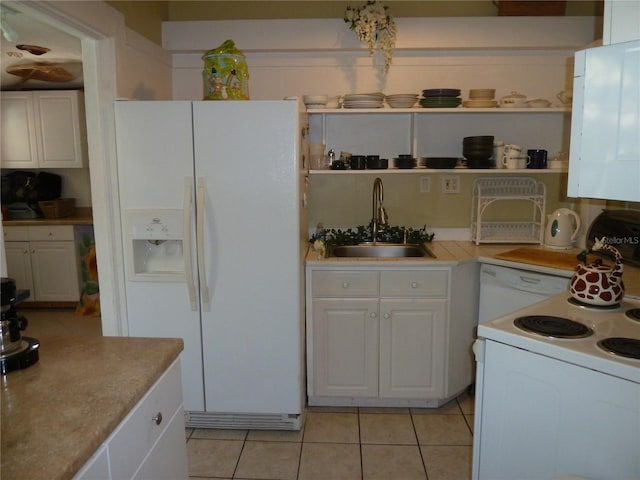 kitchen with light tile patterned flooring, white appliances, a sink, white cabinets, and open shelves