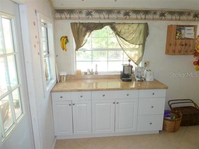 kitchen featuring light countertops and white cabinets