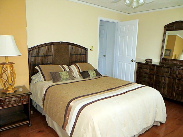 bedroom featuring wood finished floors and crown molding