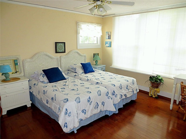 bedroom featuring a ceiling fan, dark wood-style flooring, and baseboards