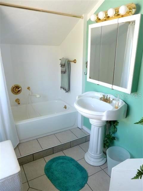 bathroom featuring tile patterned flooring and shower / washtub combination