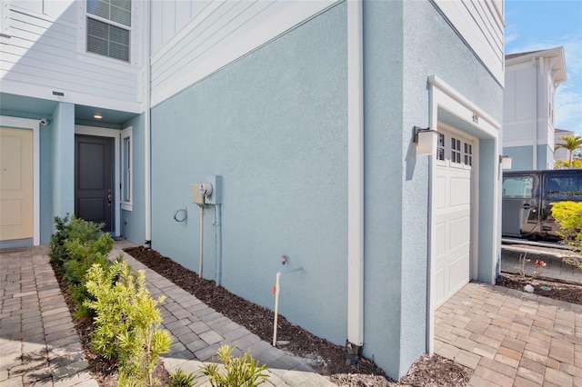 view of home's exterior featuring a garage and stucco siding