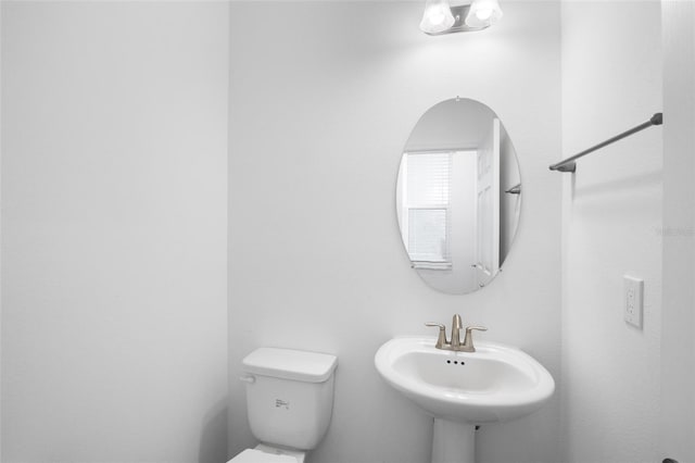 bathroom featuring toilet and a sink