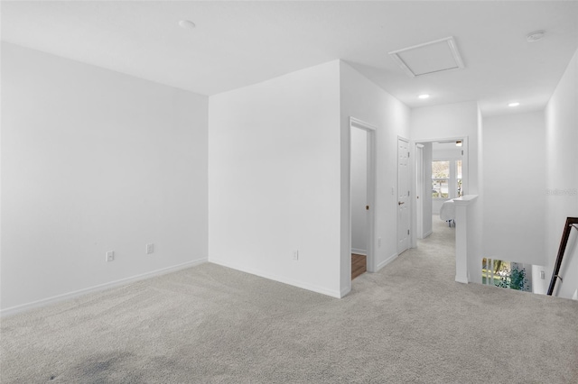 empty room with carpet floors, attic access, baseboards, and recessed lighting