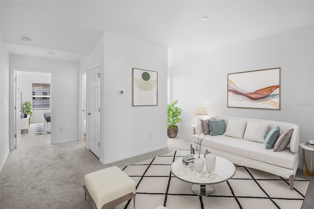 living area with light carpet and baseboards