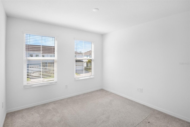 spare room with carpet floors and baseboards