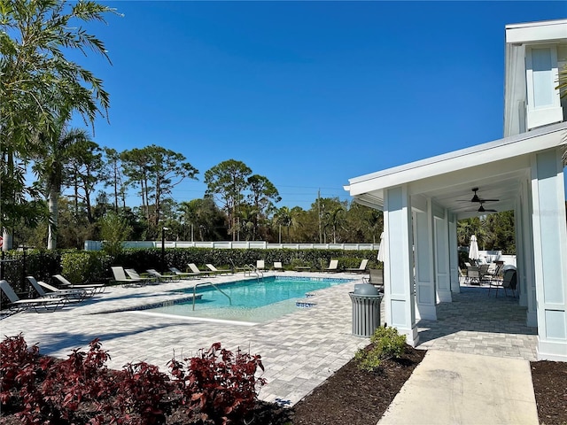 pool with ceiling fan, a patio, and fence