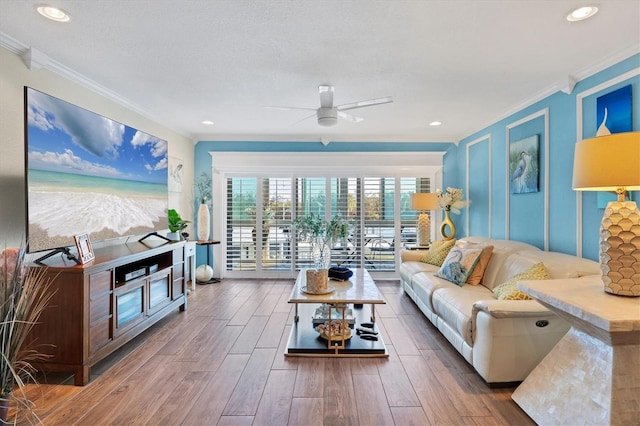 living room featuring a ceiling fan, recessed lighting, crown molding, and wood finished floors