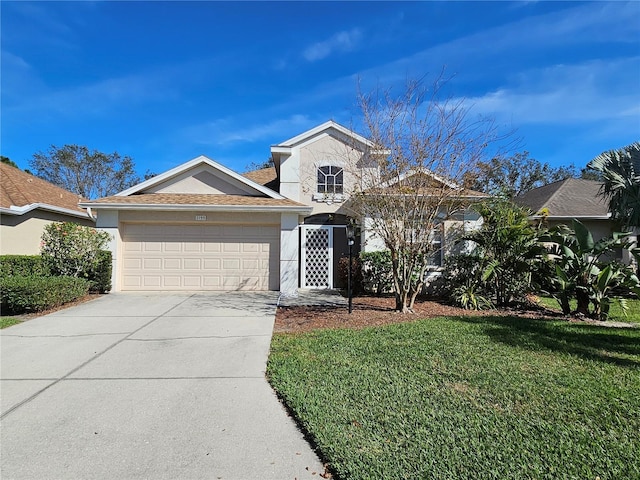 view of front facade with concrete driveway, stucco siding, roof with shingles, an attached garage, and a front yard