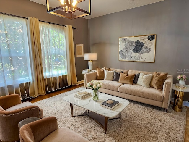 living room with a chandelier and wood finished floors