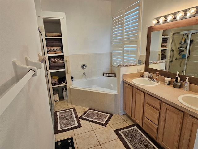 full bathroom with double vanity, a sink, tile patterned flooring, a shower stall, and a bath