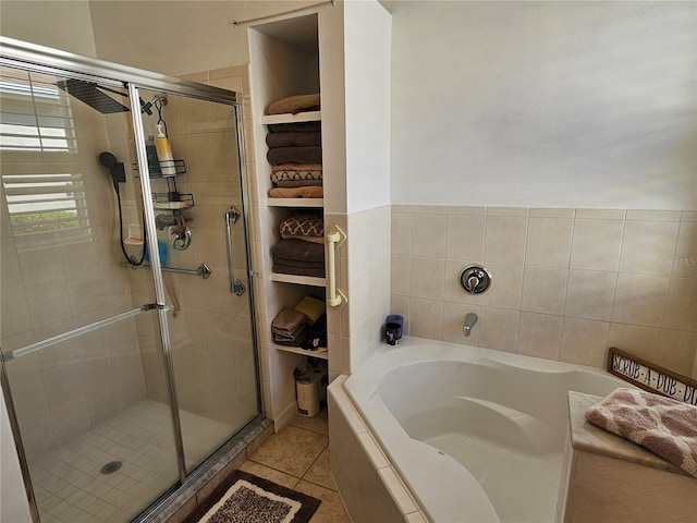 full bath featuring a stall shower, tile patterned flooring, and a bath