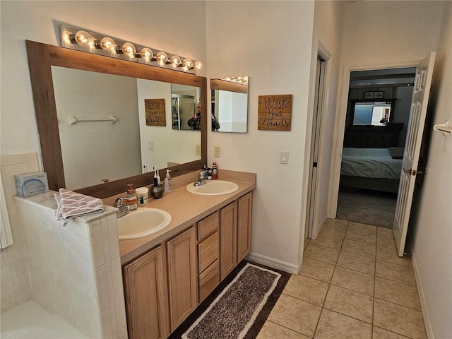 ensuite bathroom featuring double vanity, tile patterned flooring, ensuite bath, and a sink