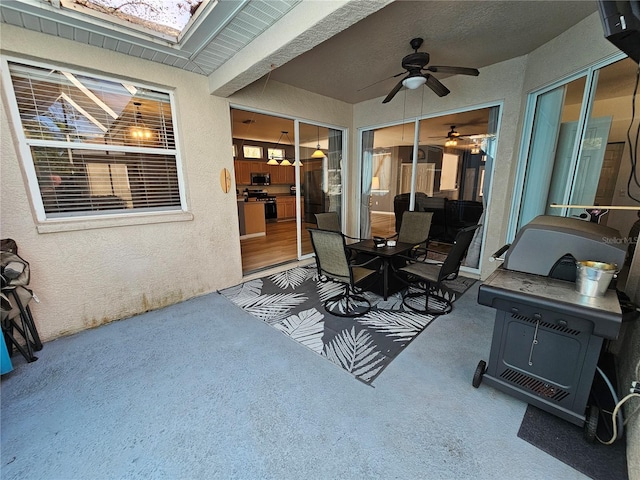 view of patio featuring ceiling fan and outdoor dining area