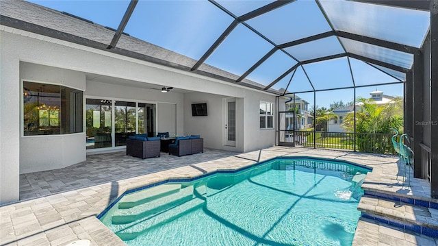 outdoor pool featuring glass enclosure, a patio area, ceiling fan, and outdoor lounge area