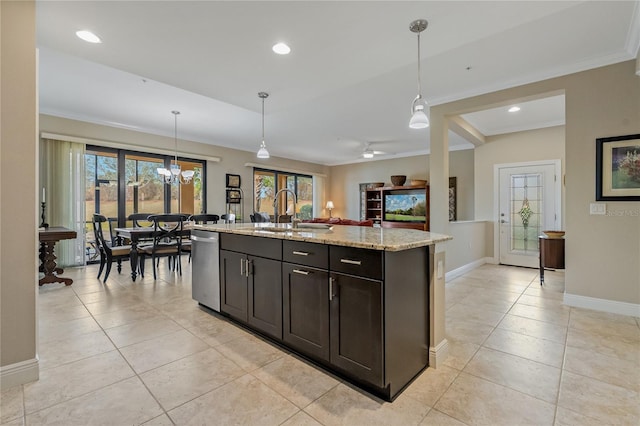 kitchen featuring decorative light fixtures, a kitchen island with sink, a sink, light stone countertops, and dishwasher