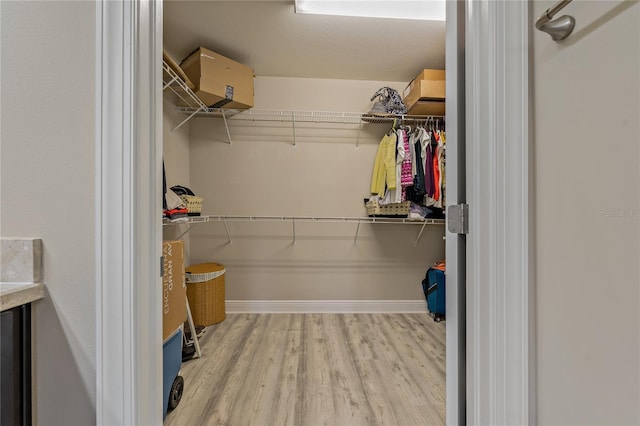 spacious closet with light wood finished floors