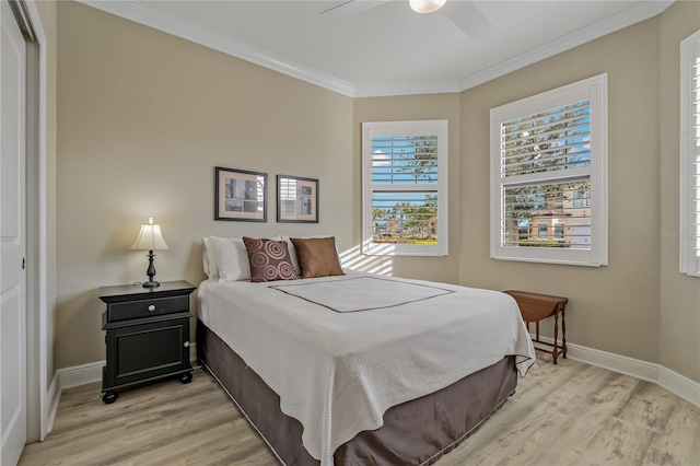 bedroom featuring baseboards, ceiling fan, light wood-style floors, and crown molding