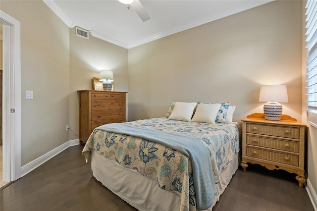 bedroom featuring dark wood-style flooring, crown molding, visible vents, ceiling fan, and baseboards