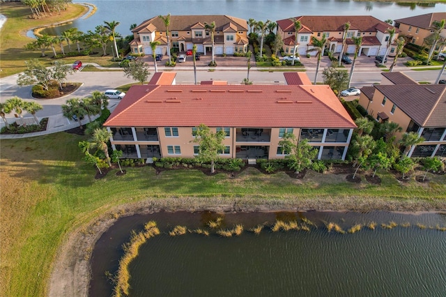 drone / aerial view featuring a water view and a residential view